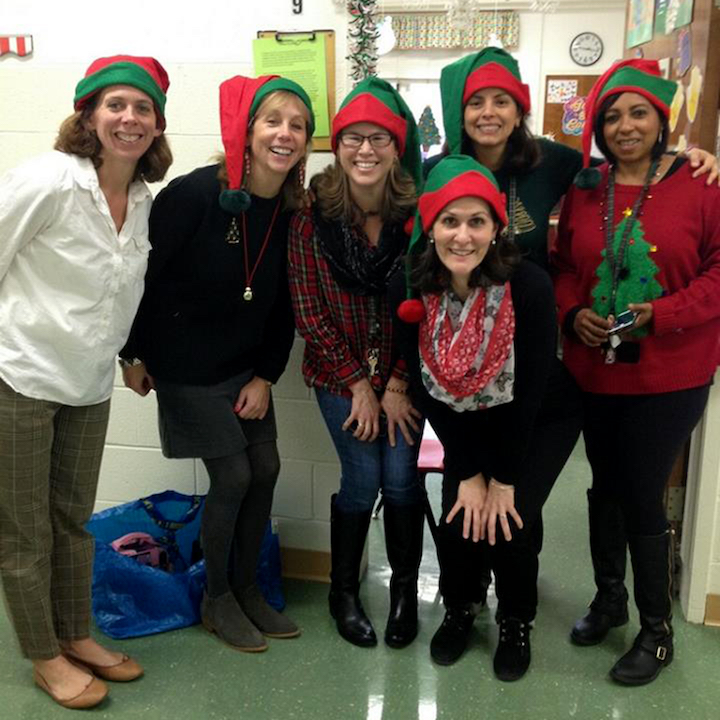 Six teachers wearing elf Christmas hats